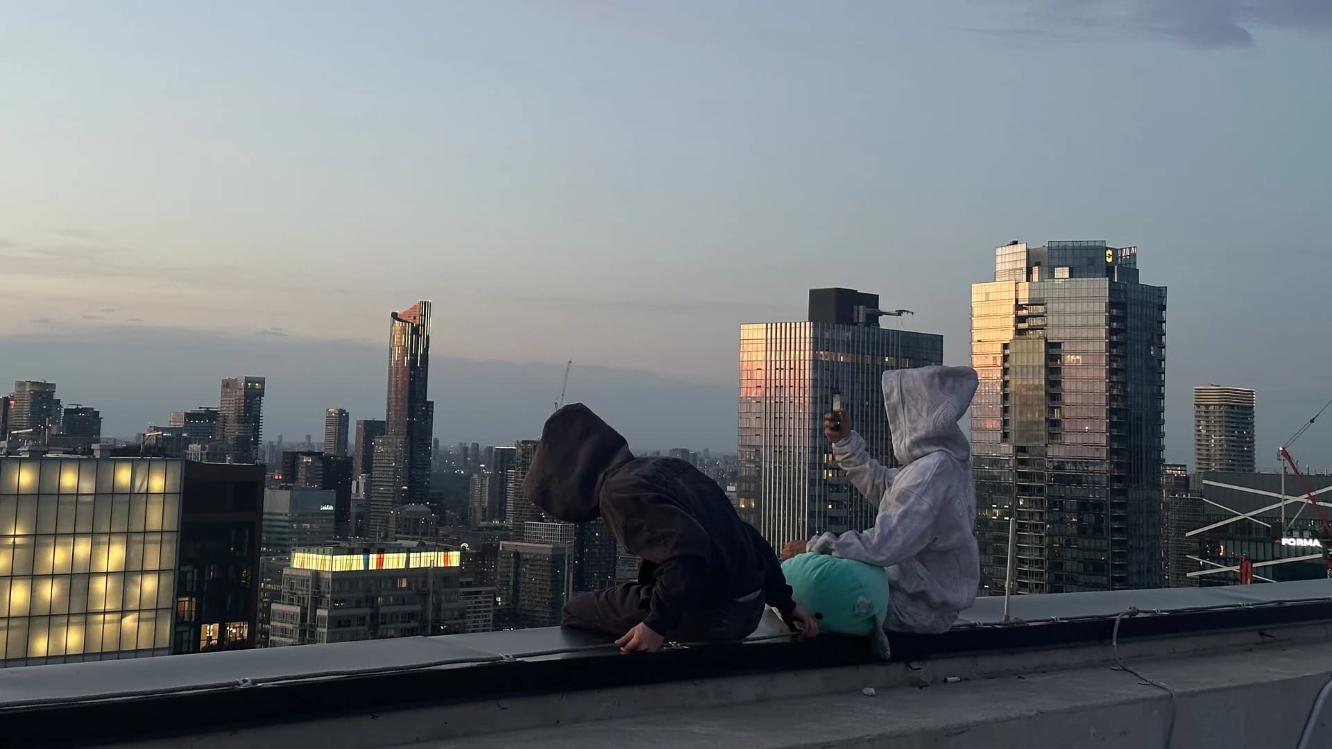 Steadfast rooftop atmosphere over the Toronto skyline.